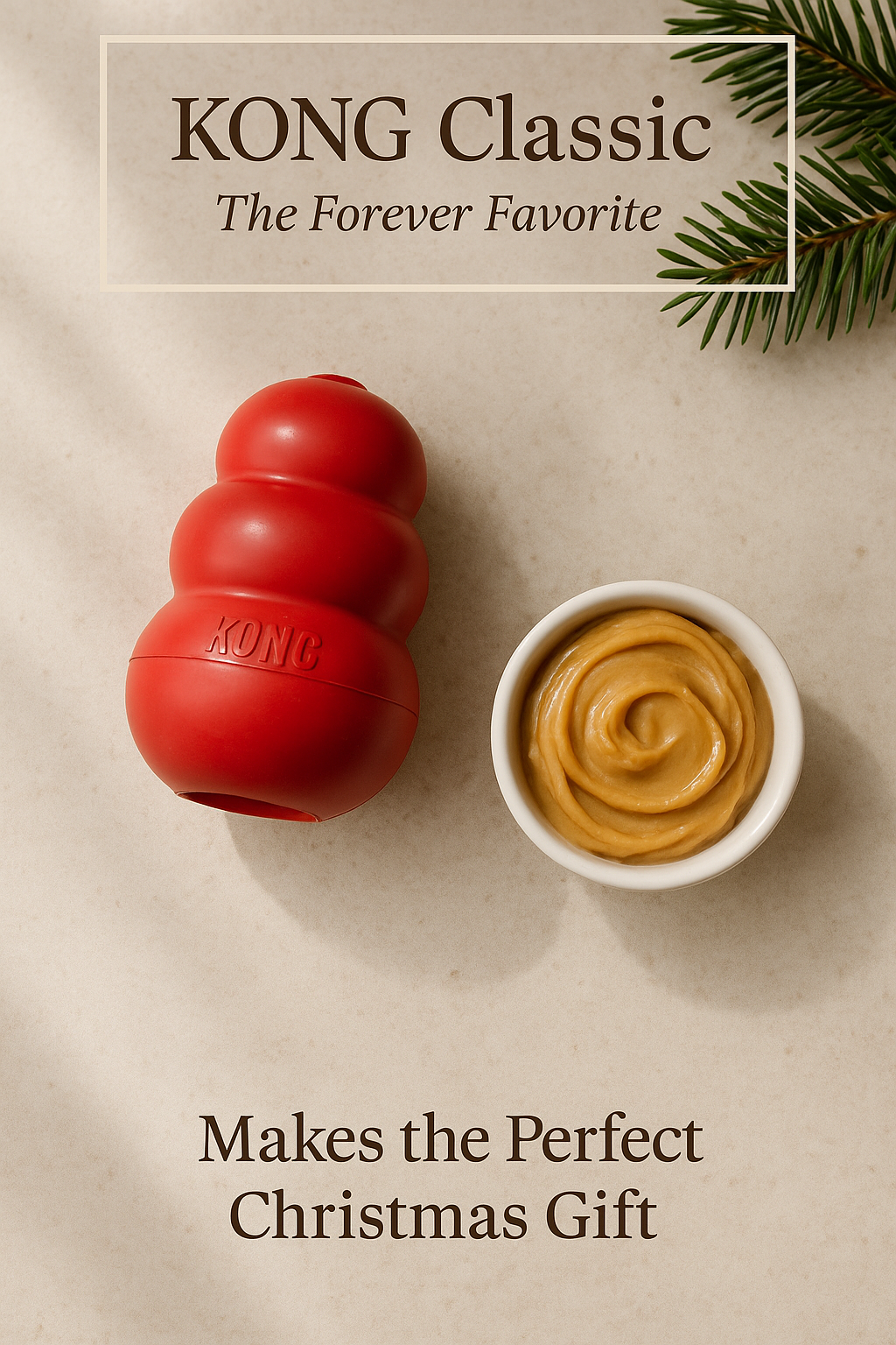 Christmas-themed flatlay of a red KONG Classic dog toy with peanut butter on a neutral background and subtle holiday greenery.